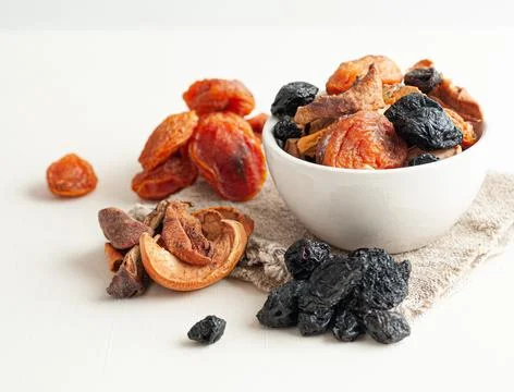 Dried fruit mixture consisting of apples, pears, prunes and apricots. In a wh Stock Photos