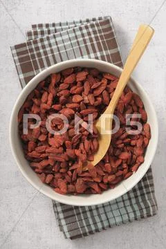 Dried Gojiberries In A Bowl With A Wooden Spoon