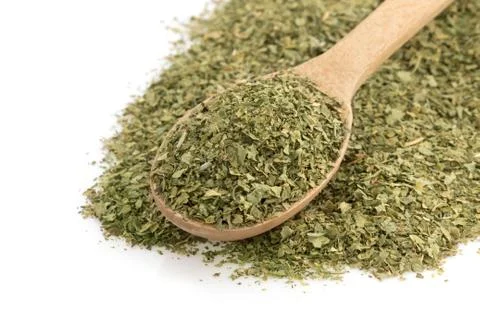 Dried green spices in spoon Stock Photos