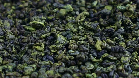 Dried green tea leaves falling down close up Stock Footage 238481412