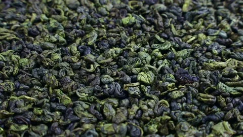 Dried green tea leaves texture rotation close up 스톡 동영상 238404834