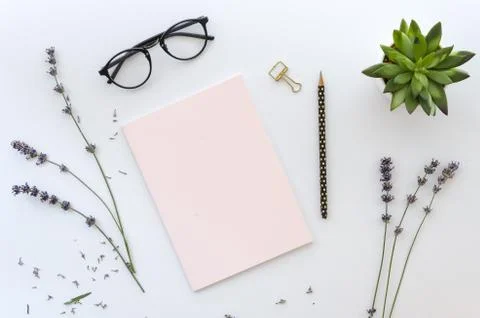 Dried lavender around pink note and a black pencil on white background for your Stock Photos