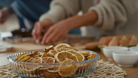Dried lemons in the foreground and human hands of unrecognizable people Stock Footage 218807560