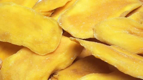 Dried mango close-up. yellow pieces of manga close-up moves in a circle Stock Footage 233625728