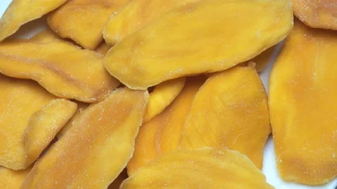Dried mango close-up. yellow pieces of manga close-up moves in a circle Stock Footage 236643161