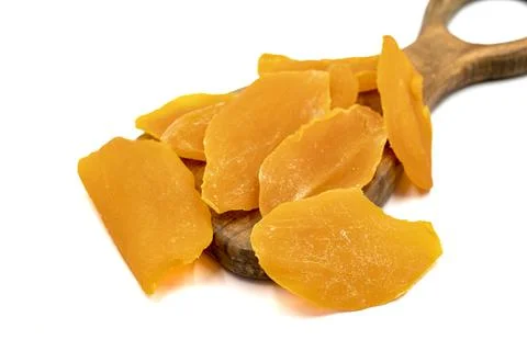 Dried mango slice isolated on white background. Dried fruit in sunlight. clos Stock Photos