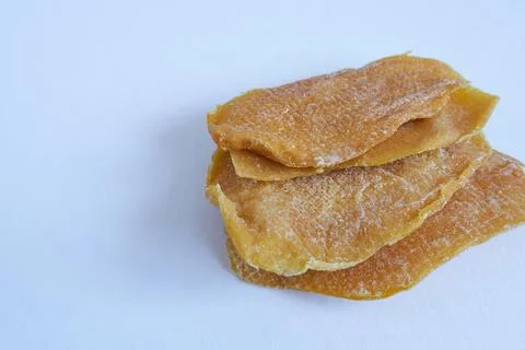 Dried mango slices on white background. Stock Photos