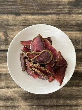 Dried meat slices on a plate Stock Photos