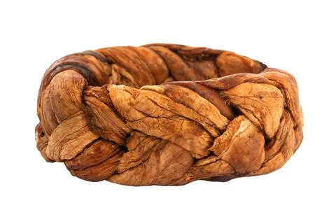 Dried melon in the shape of a pigtail on a white background. Dried melon frui Stock Photos