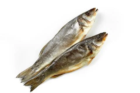 Dried mullet. Close-up, selective focus. White background. Stock Photos