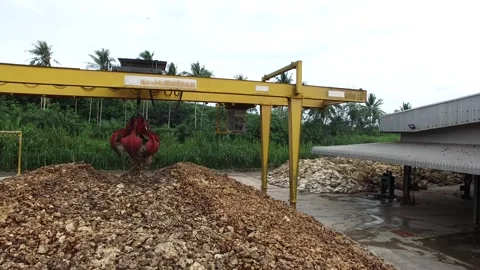 Dried Natural Raw Rubber Piled on Cement Ground with Mechanical Grabber Video stock 296523063