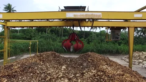 Dried Natural Raw Rubber Piled on Cement Ground with Mechanical Grabber Video stock 296523084