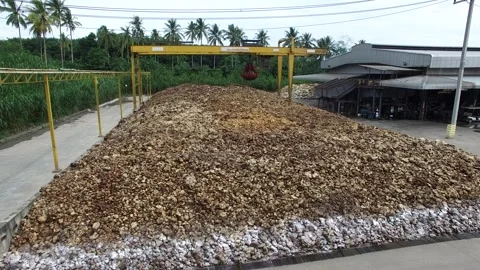 Dried Natural Raw Rubber Piled on Cement Ground with Mechanical Grabber Video stock 296523099