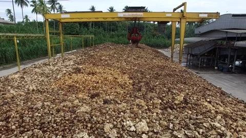 Dried Natural Raw Rubber Piled on Cement Ground with Mechanical Grabber Video stock 296523114
