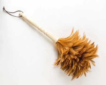 Dried orange feather flower with string on white background Stock Photos