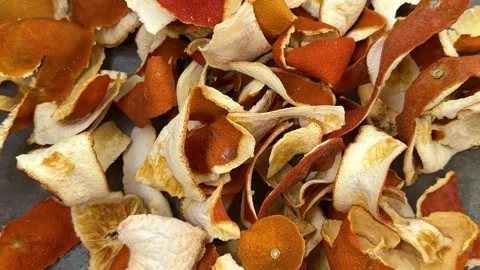 Dried orange peels scattered on gray concrete surface, closeup texture Video stock 342438257