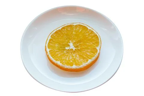 Dried orange slice on a plate. Stock Photos