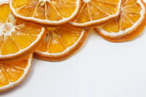 Dried orange on a white background. Round slices of dried orange. Stock Photos