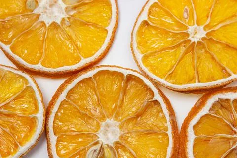 Dried orange on a white background. Round slices of dried orange.  Stock Photos