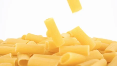 Dried pasta macaroni falling on a heap on a white background, slow motion Stock Footage 92424991