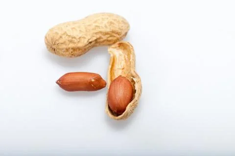 .dried peanuts in closeup on the white background Stock Photos
