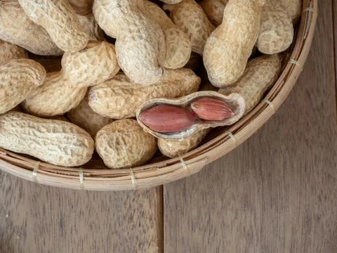 Dried peanuts in shells on peanuts background on wooden table. Concept of sna Stock Photos