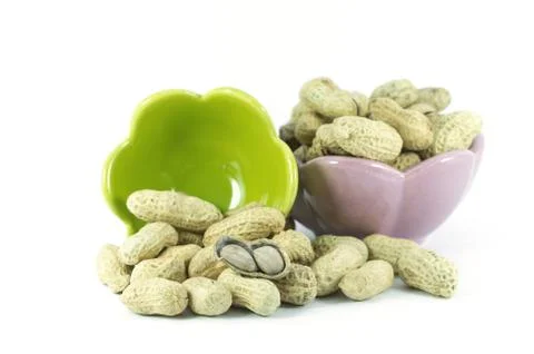 Dried peanuts in small cups on the white background Foto stock