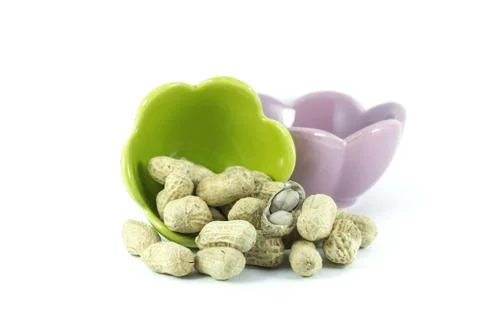 Dried peanuts in small cups on the white background Stock Photos