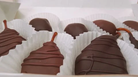 Dried pears and dates in chocolate. Chocolate candies in Gift Box extreme close Stock Footage 149210807