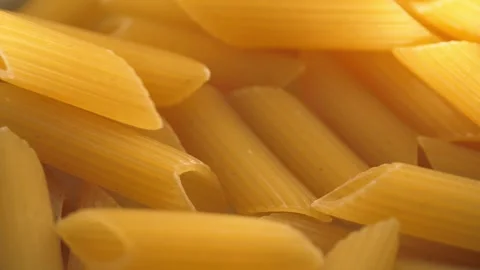 Dried Penne Pasta falling close up macro shot selective focus Stock Footage 286733711