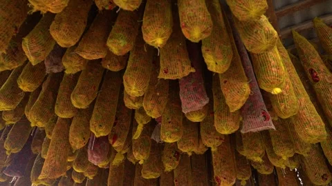 Dried pepper pods hanging in mesh bags for seasoning and spice production Stock Footage 333521187
