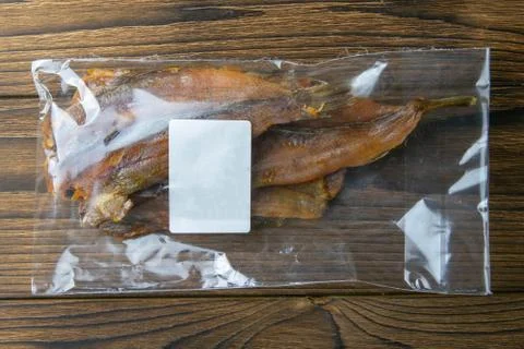 Dried perch in a transparent package white label appetizer to beer on wooden  Stock Photos