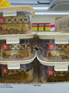 Dried plums in clear containers on retail shelf Stock Photos