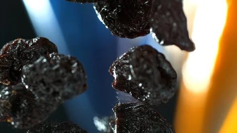 Dried plums , dried prunes falling to the water table. SLOW MOTION, 4K Stock Footage 114965284