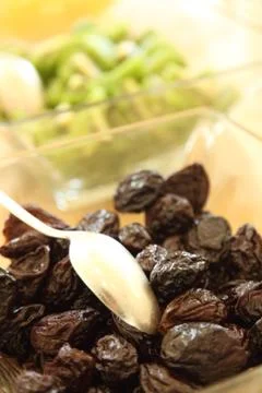 Dried plums with a spoon Stock Photos