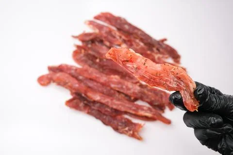 Dried pork isolated on white background. Pieces of dry meat. Beer snack. Stock Photos