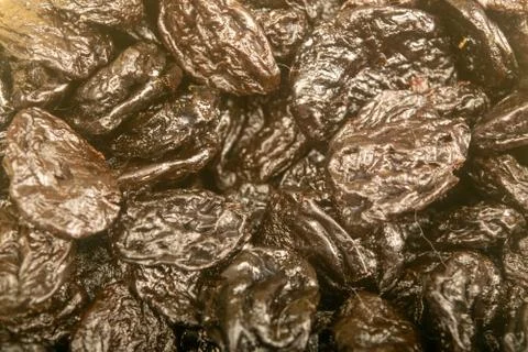 Dried prunes in bulk. Surface texture. Close up. Stock Photos