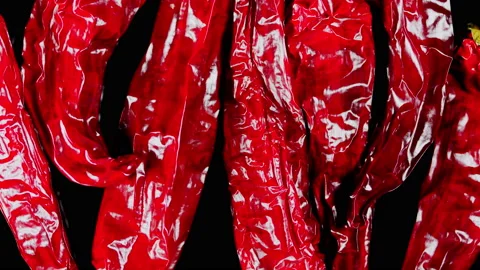 Dried red chilli on black background. Spicy food concept. Video stock 165764079
