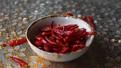 Dried red chilli falling in a bowl Stock Footage 332688723