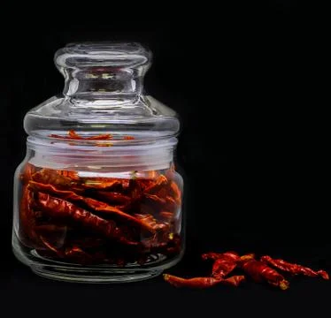 Dried Red Chilli In Glass Container in Black Background Stock Photos