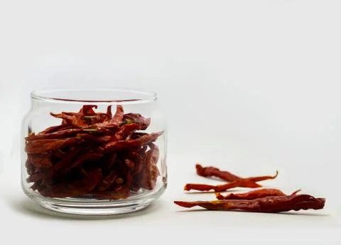 Dried Red Chilli In Glass Container in White Background Stock Photos