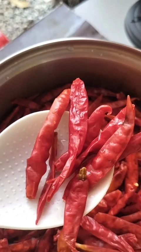 Dried Red Chillies Soaking and Boiling in Water for Spice Paste Stock Footage 323243467