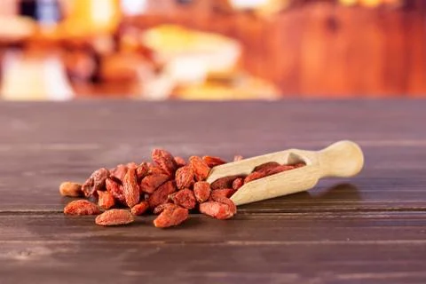 Dried red goji berries with rustic kitchen Stock Photos