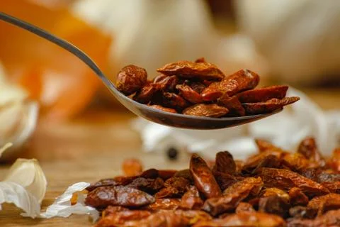 Dried red hot small chilli peppers in spoon Stock Photos