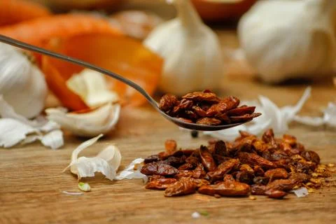 Dried red hot small chilli peppers in spoon Stock Photos