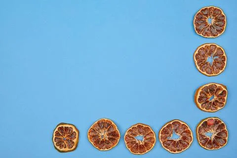 Dried red oranges on a blue background with place to insert Stock Photos