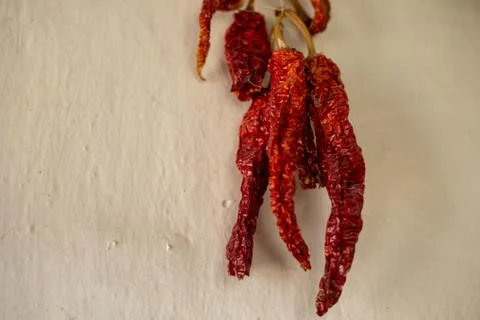 Dried red pepper in a bundle on the wall Stock Photos