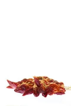 Dried red pepper on a white background tied together Stock Photos