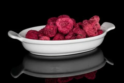 Dried red raspberry isolated on black glass Stock Photos
