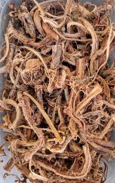 Dried red root pieces from Hedysarum used in herbal medicine and wellness r.. Stock Photos